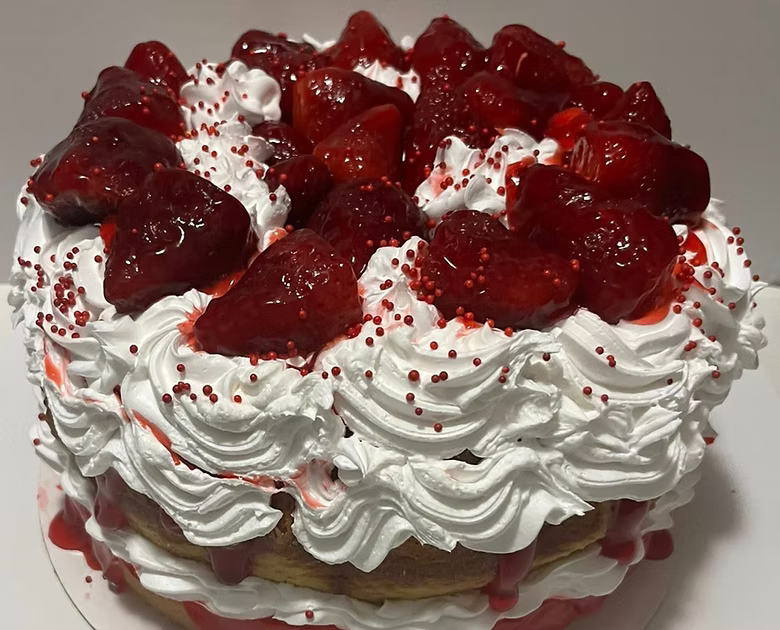 Cake with Whipped Crean strawberries, and red sprinkles on a white background Butter cake